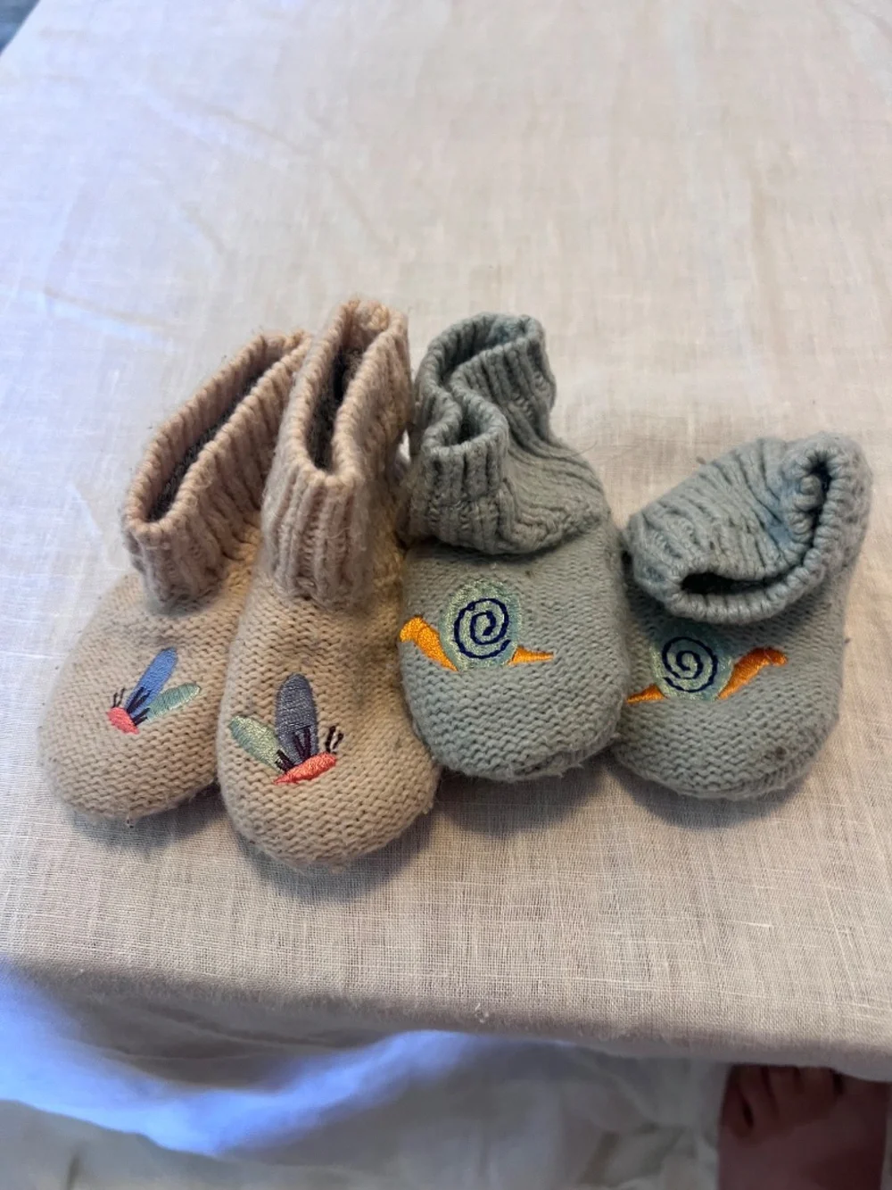 5 squid sock pairs in different styles for 6-12M, and 2 Bombas booties 6-12M